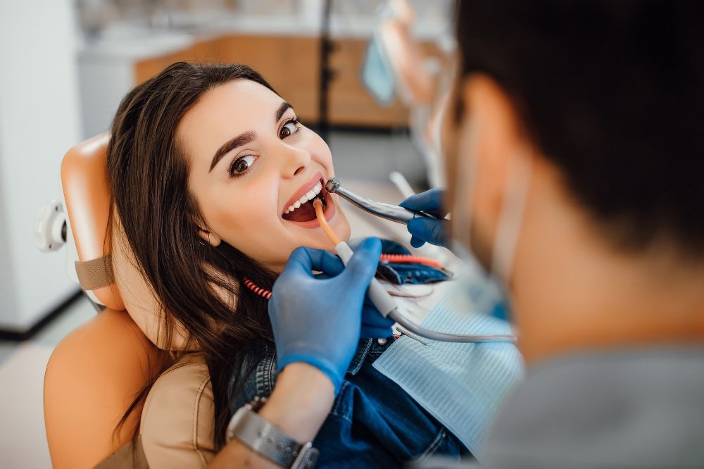a woman is getting dental treatment.