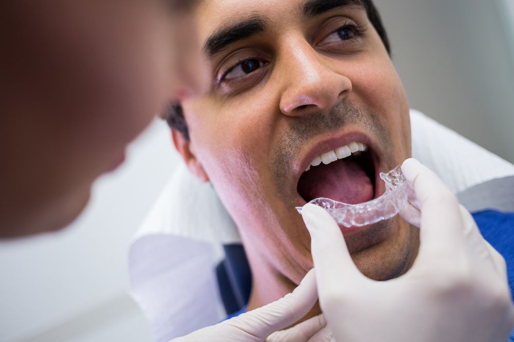 a man is getting dental treatment.