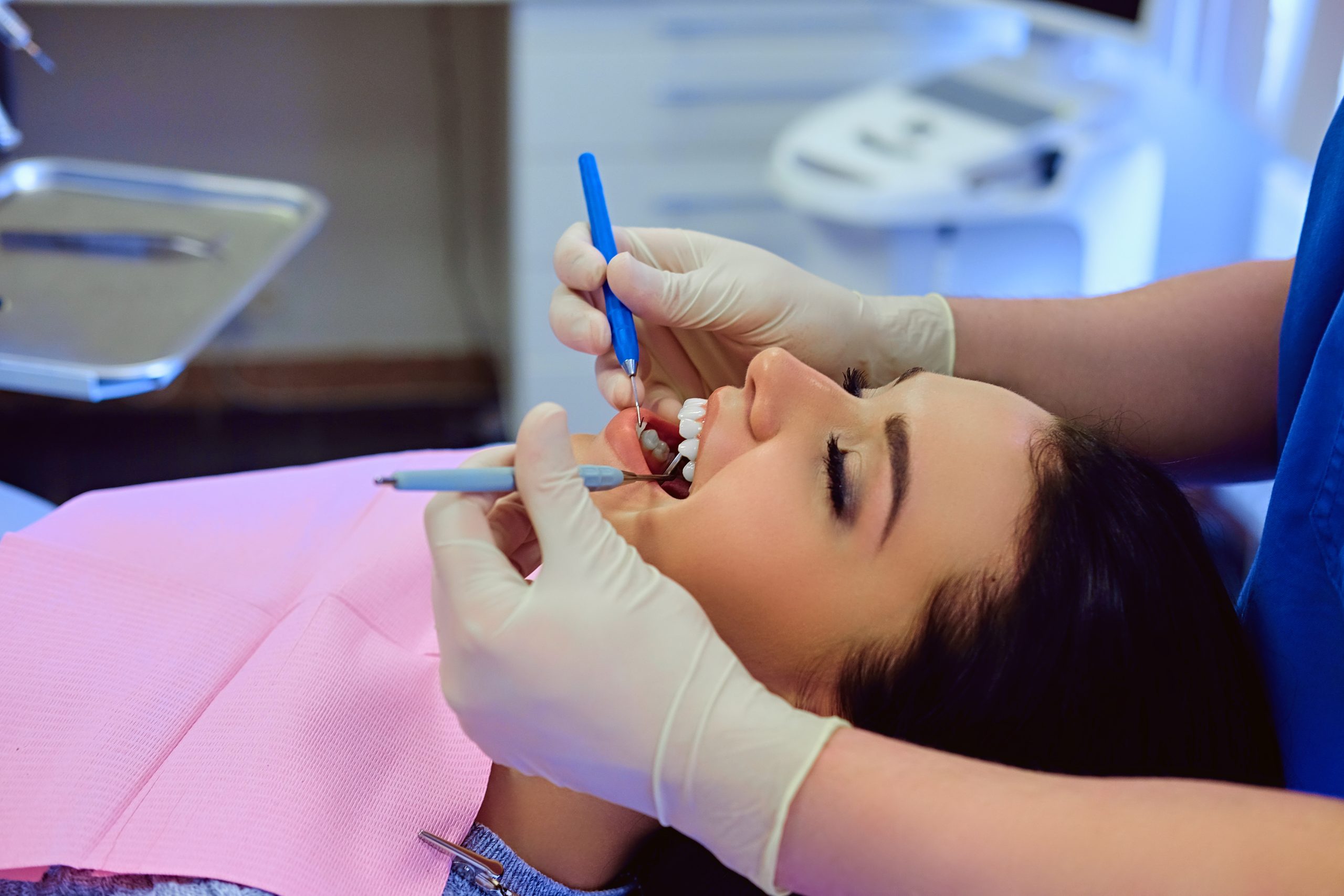 a woman is getting dental treatment.